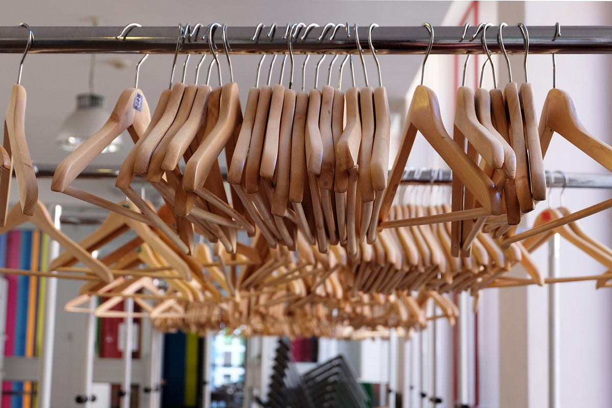 Clothes hangers on railing (Unsplash)